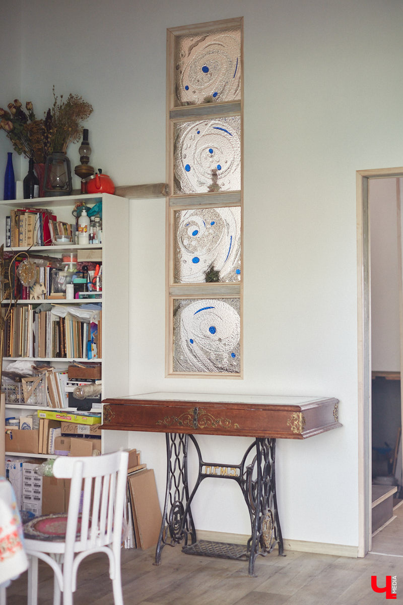 Никакого сайдинга поверх вековых бревен и никакой сдачи в утиль бабушкиной утвари. Превращать пятистенок с дощатой террасой на Пушкарской в собственную крепость художница Елена Сахарова начала постепенно. Комнаты с годами превращались в галерею работ самой Елены, ее друзей, а позднее и дочери. Дом хранит немало интересных коллекций, но все главные чудеса происходят в подвале, где рождаются яркие, сияющие картины, волшебный сплав хрупкого стекла и прочного металла.