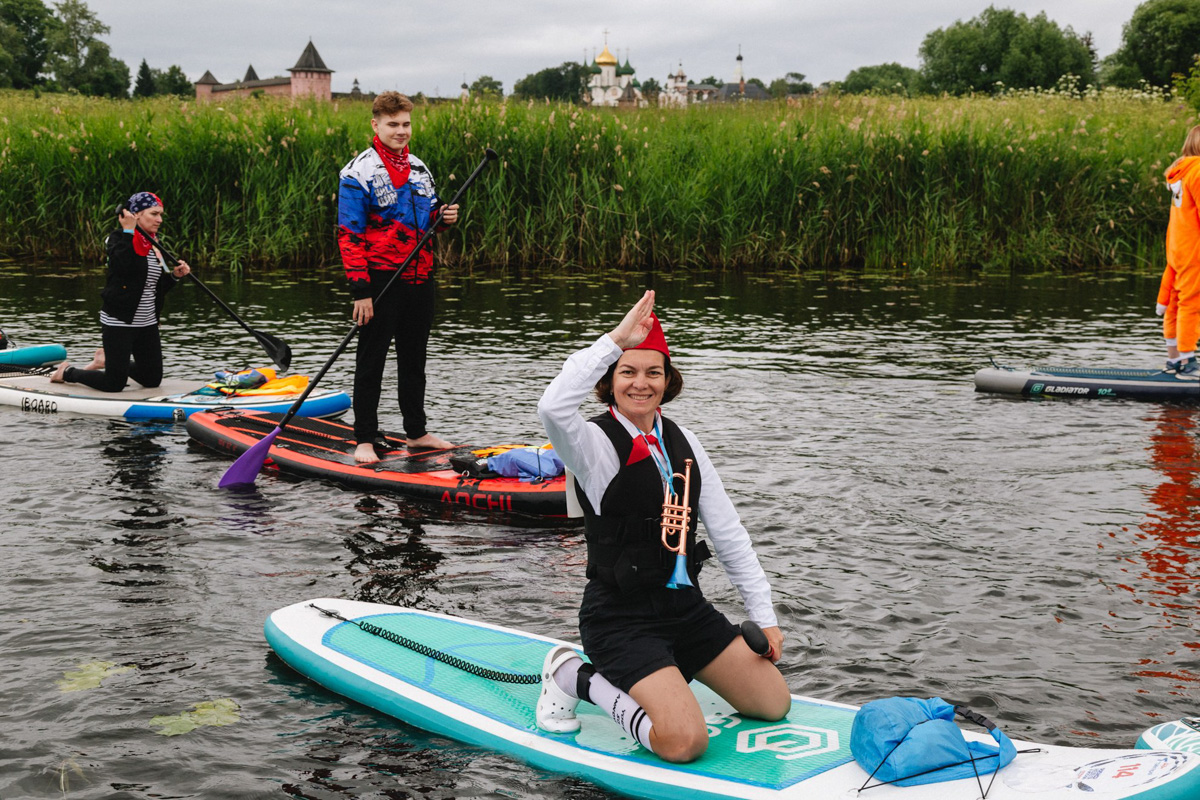 В минувшую субботу прошел второй в истории Суздаля карнавал на sup-бордах. Водный маршрут необычного фестиваля составил три километра по самому центру древнего города. Огромное количество знакомых героев из популярных сказок и культовых фильмов встали на доски и взяли в руки весла. Делимся подробностями этого неоспоримо яркого и зрелищного шоу.