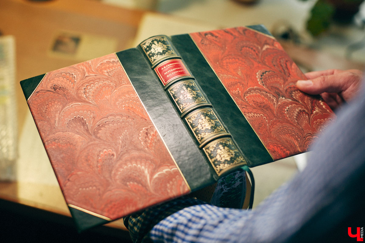 Теплый свет лампы падает на           массивную книгу с           причудливыми иллюстрациями. Рядом лежит сильно потрепанная, но           все еще роскошная обложка с           рельефными узорами и           золотыми буквами: «Фауст» Гете. В           современных книжных магазинах такой не           найдешь           — антикварный экземпляр. Над ним колдуют реставраторы из           Владимира. Вячеслав Самарский и           Лев Тимофеев впервые решили рассказать о           своей работе и           провели экскурсию по           мастерской для «Ключ-Медиа».